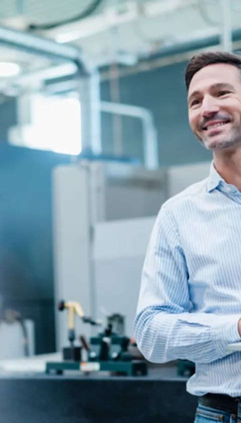 Smiling business man holding a computer