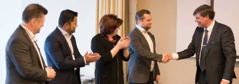 Representatives from Gothia and DNV GL shake on the acquisition deal